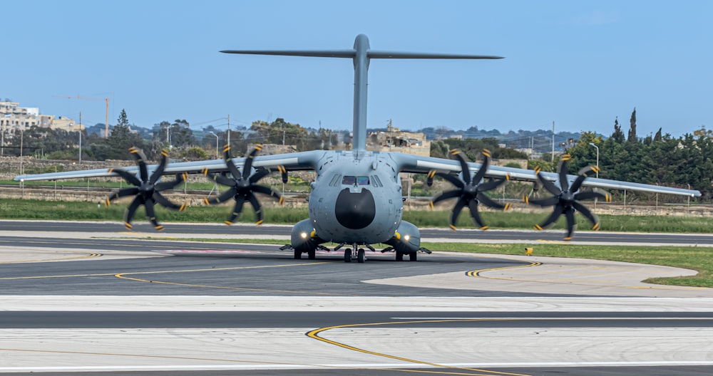 a large propeller plane sitting on top of an airport runway