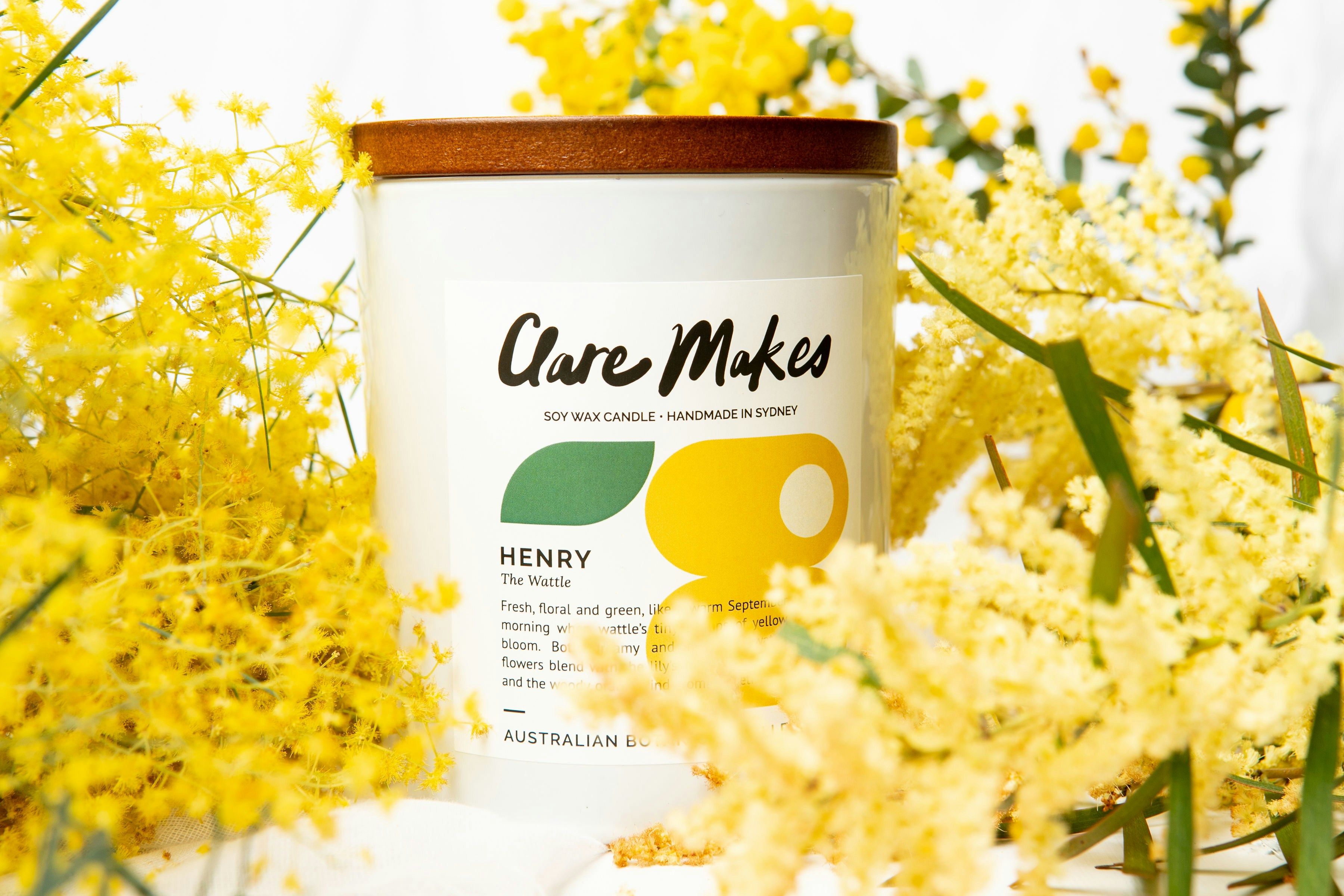 a close up of a jar of honey surrounded by flowers