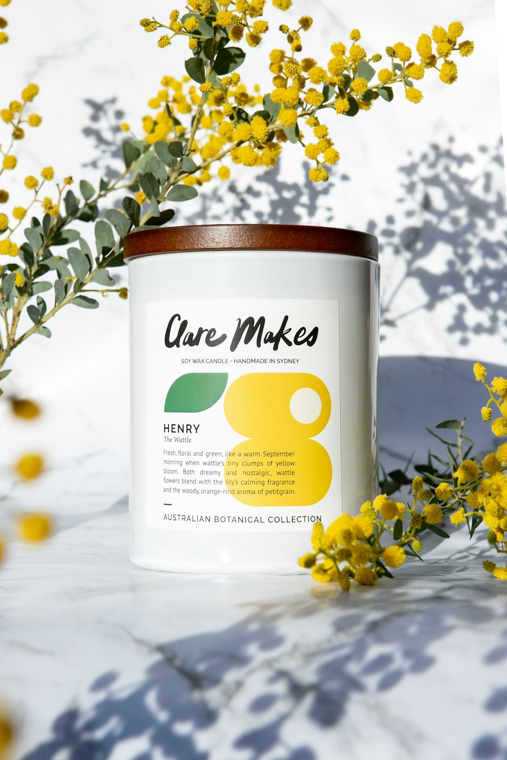 a can of care maker next to some yellow flowers