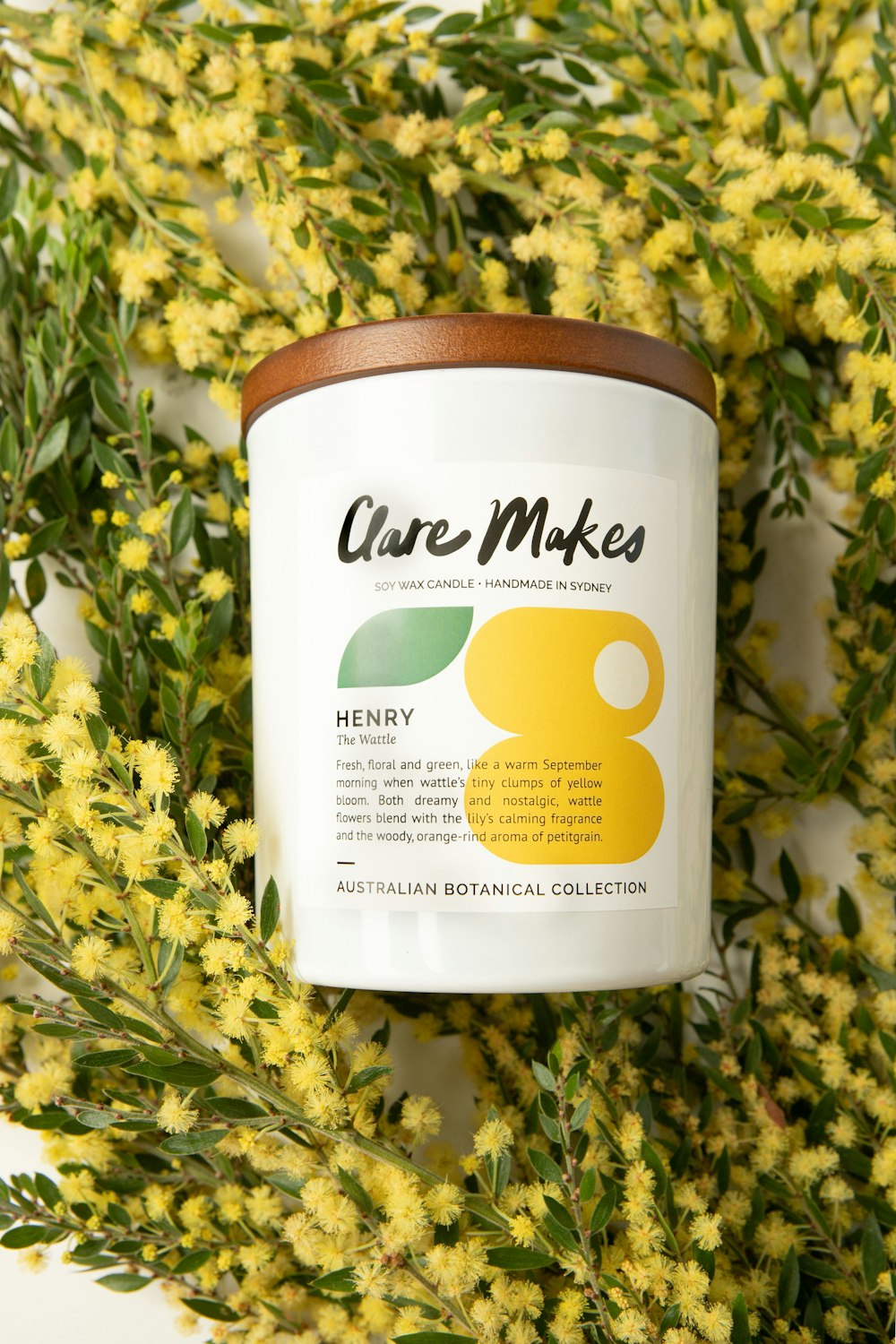 a jar of honey surrounded by yellow flowers