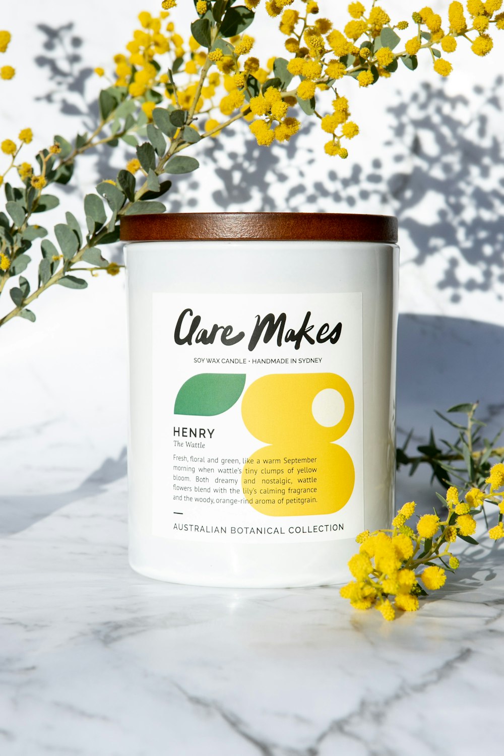 a jar with a label on it sitting next to some yellow flowers