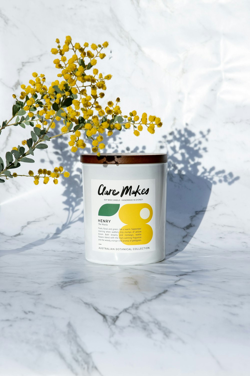 a white can with yellow flowers in it