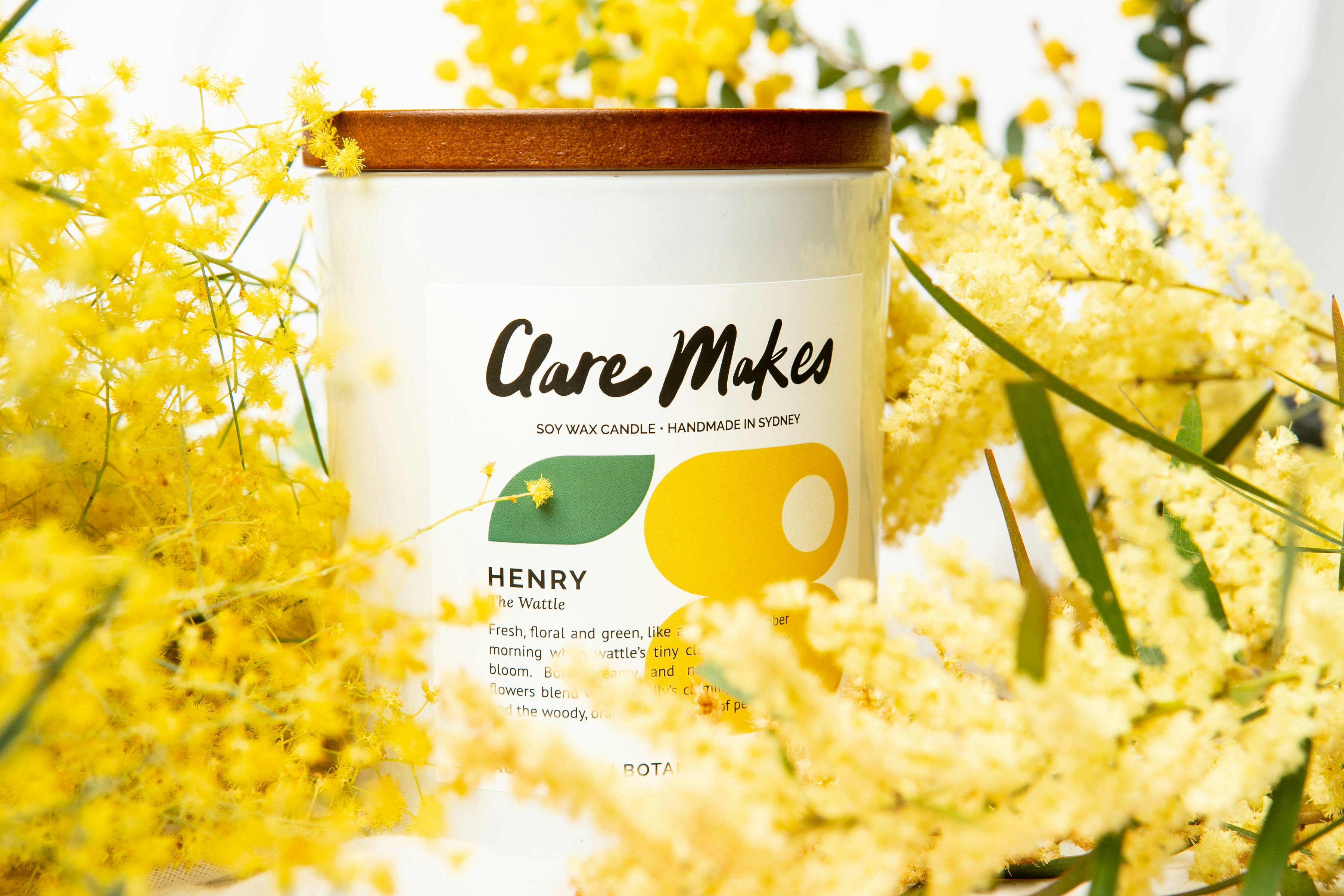 a jar of honey surrounded by yellow flowers