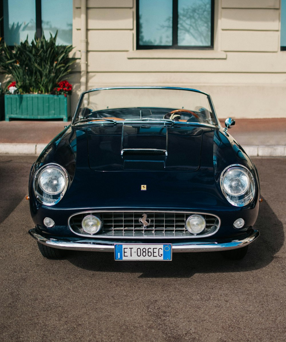 a classic car parked in front of a building