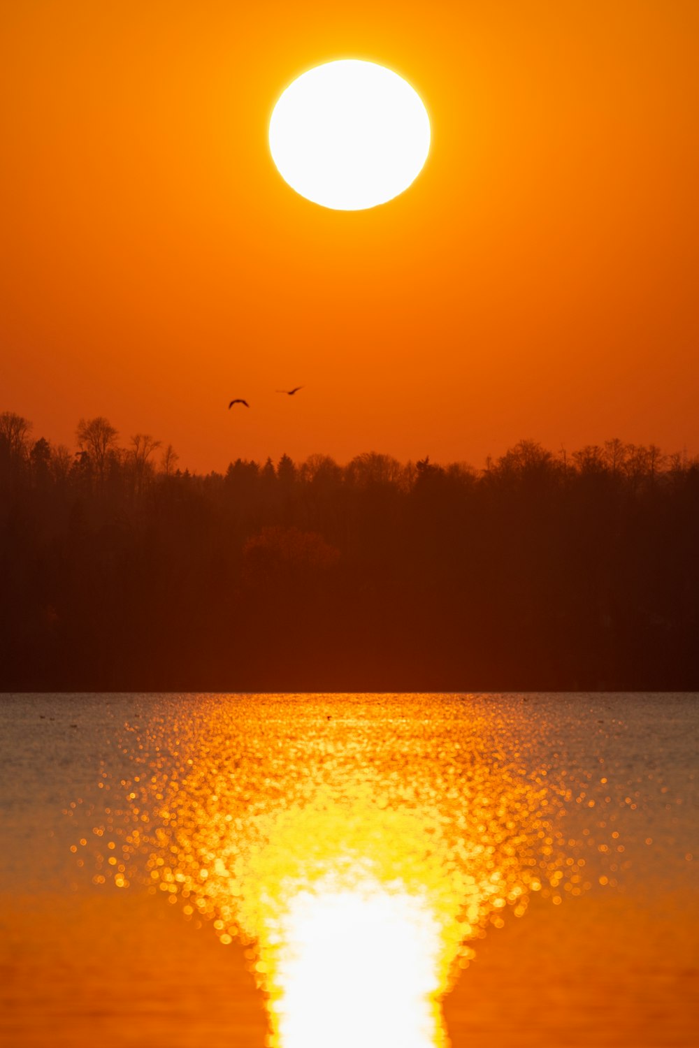 the sun is setting over a body of water