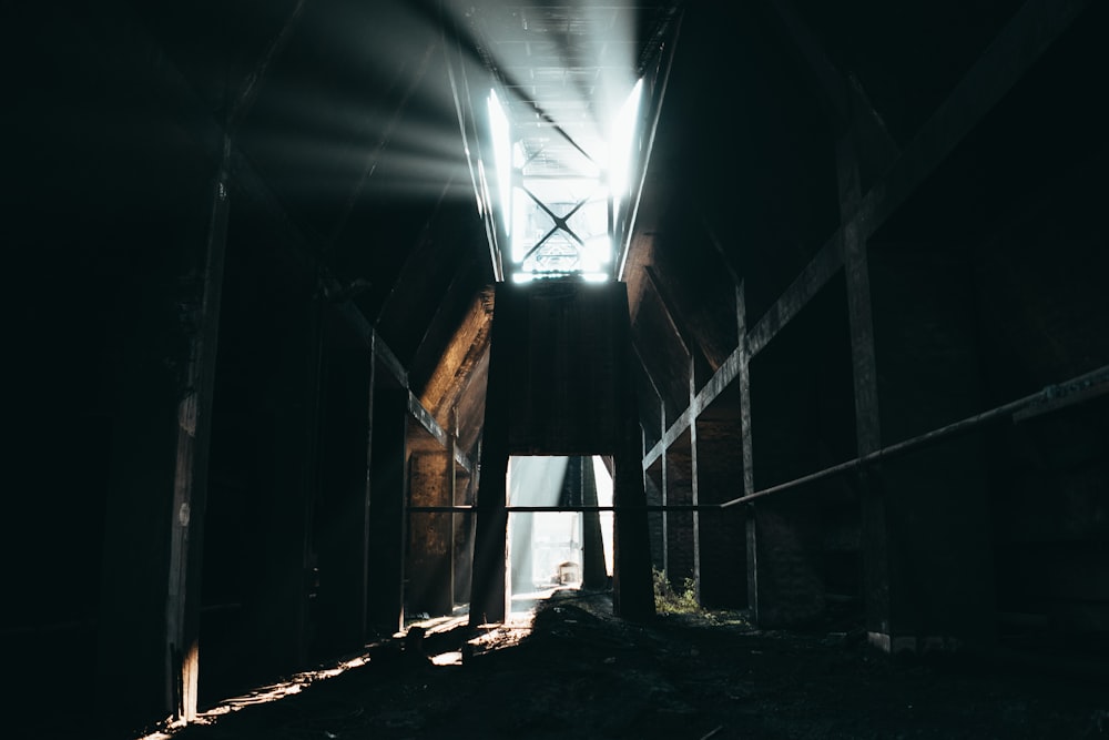 a dark room with a light coming from the ceiling