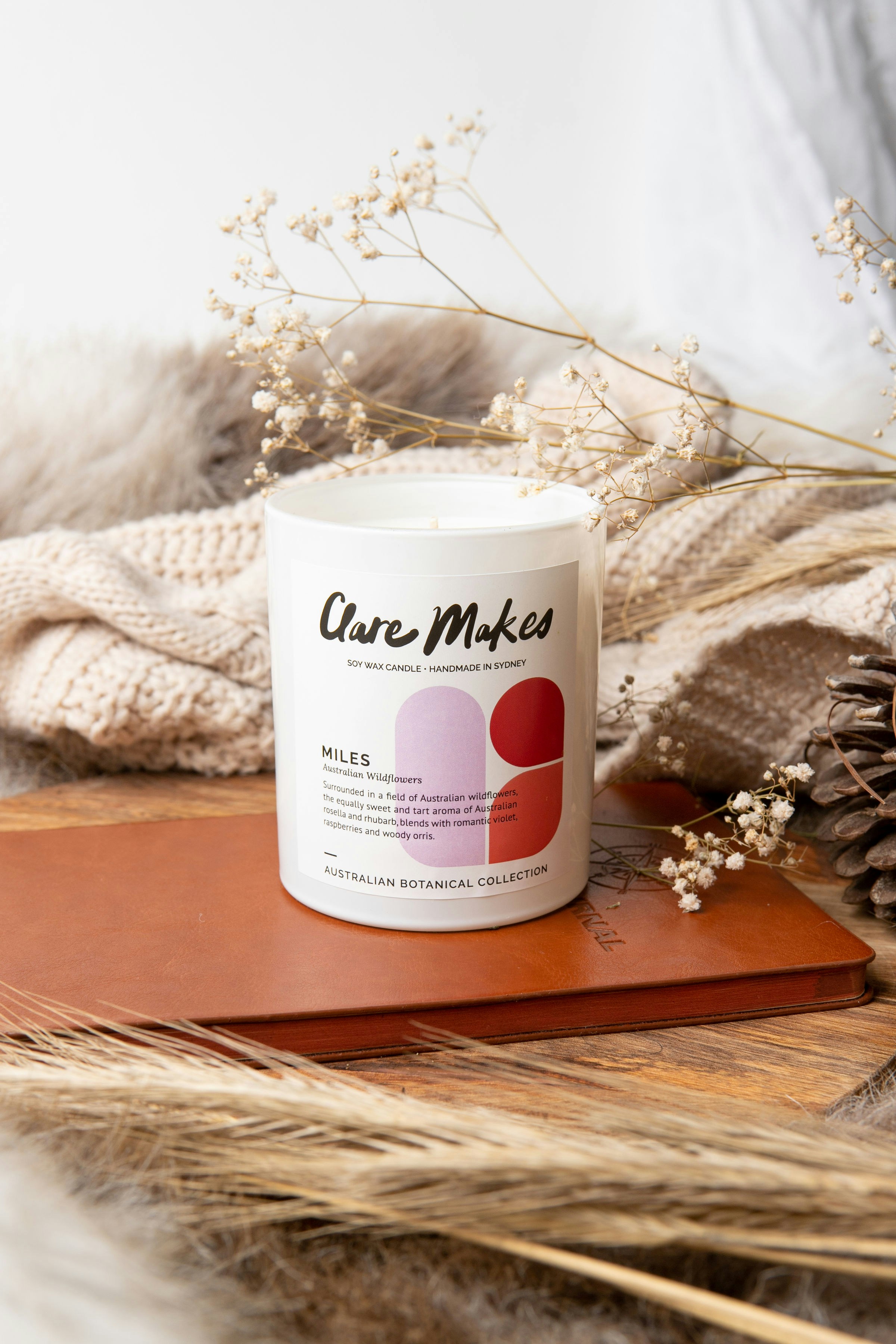 a white candle sitting on top of a wooden table