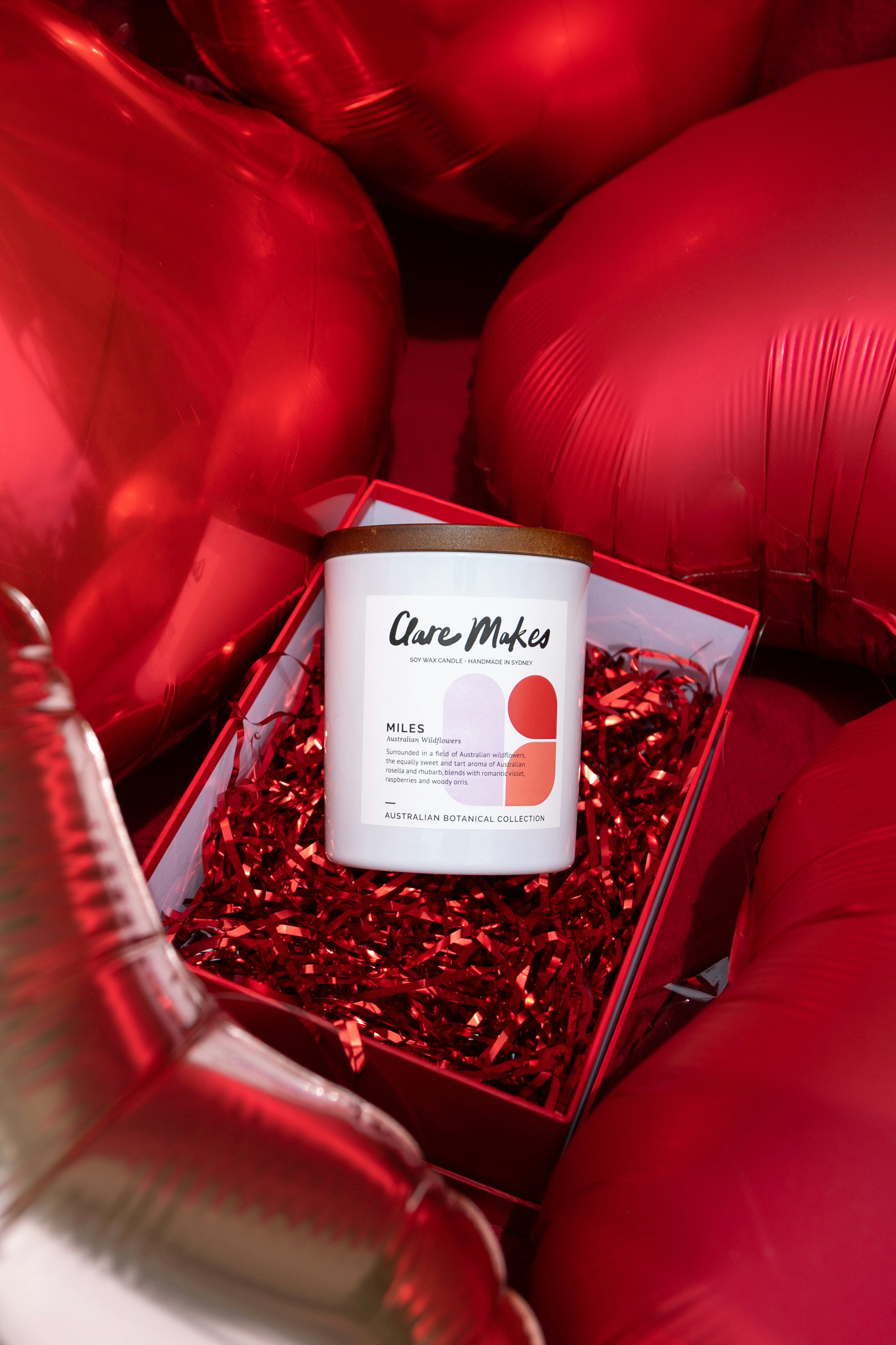 a red box filled with red foil balloons