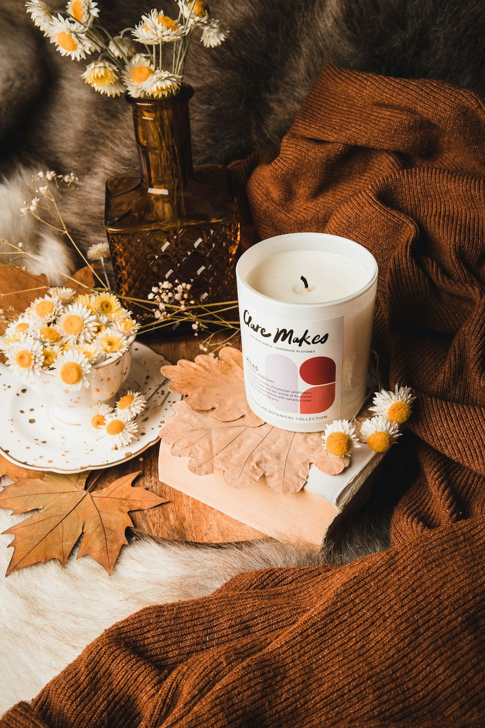 a candle and some flowers on a table