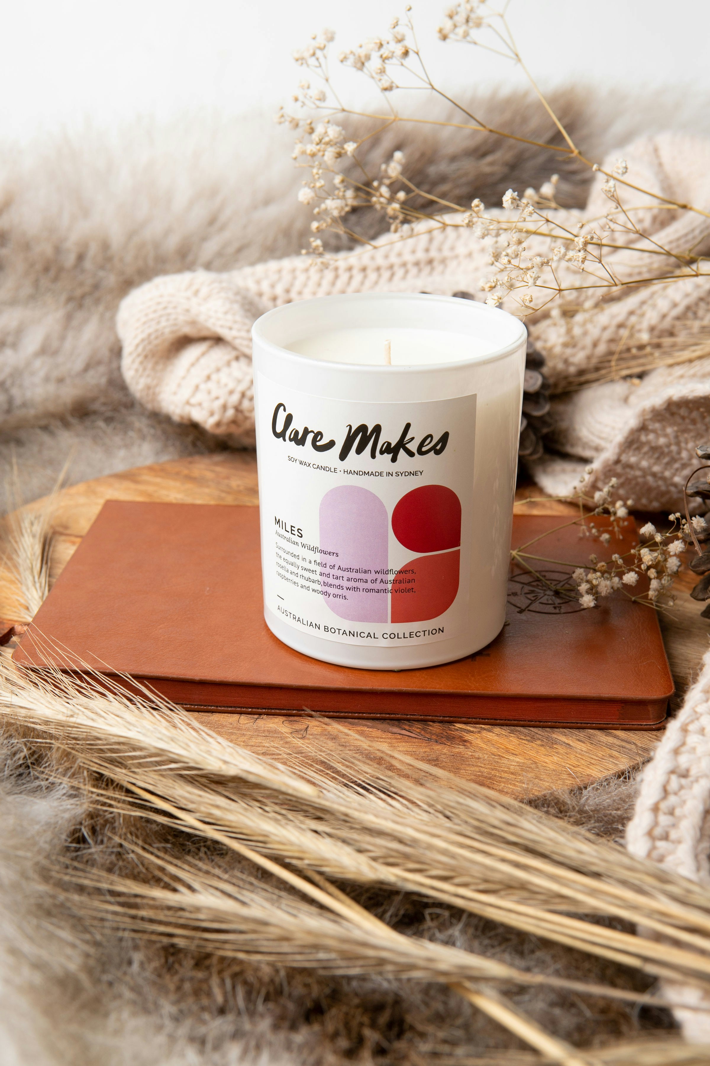 a white candle sitting on top of a wooden table