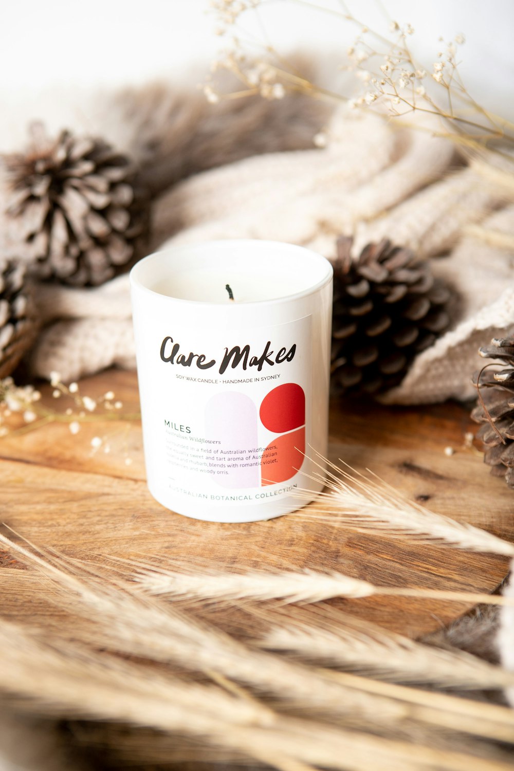 a white candle sitting on top of a wooden table