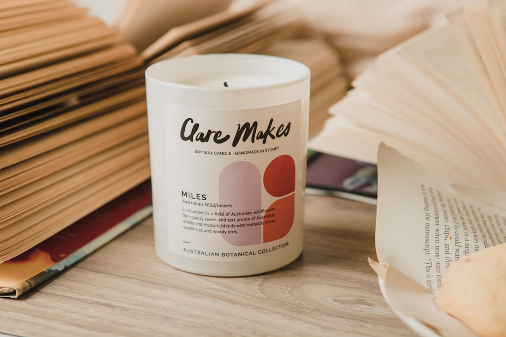 a candle sitting on top of a table next to a stack of books