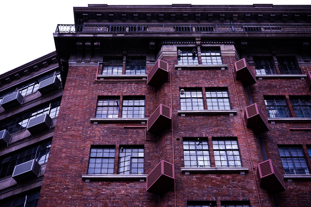 a tall brick building with many windows and balconies