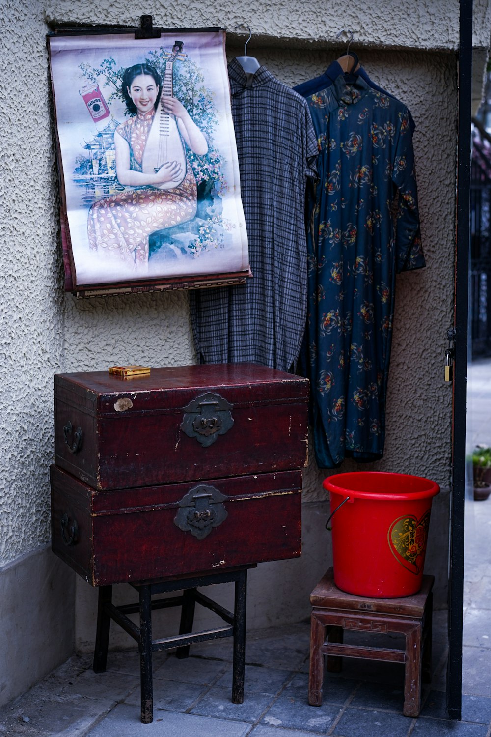 a picture of a woman hanging on a wall next to a chest of drawers