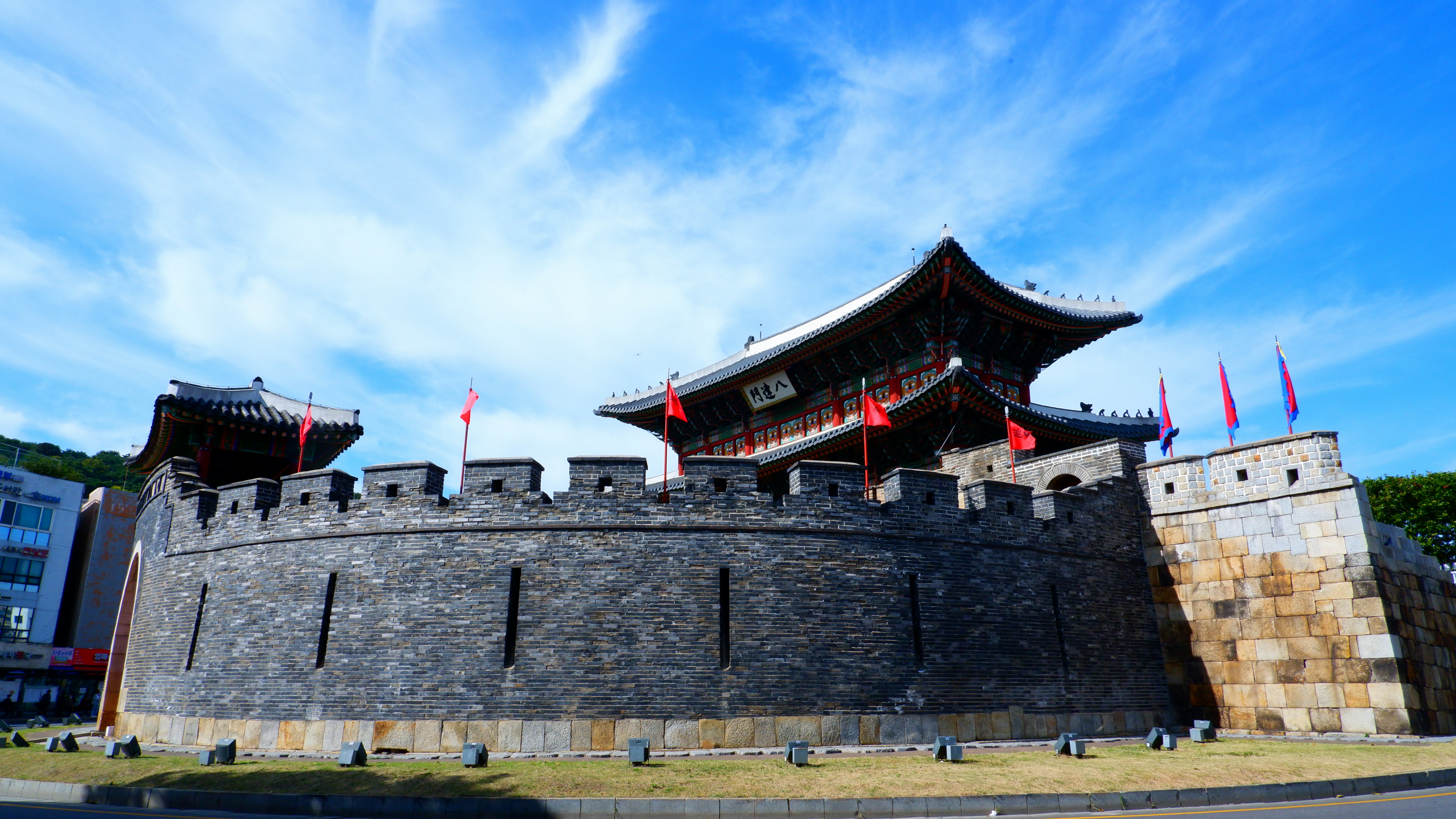 a large stone wall with flags on top of it