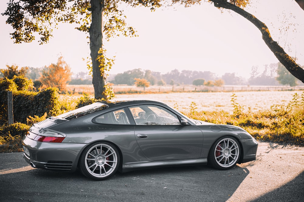 a grey sports car parked in a parking lot