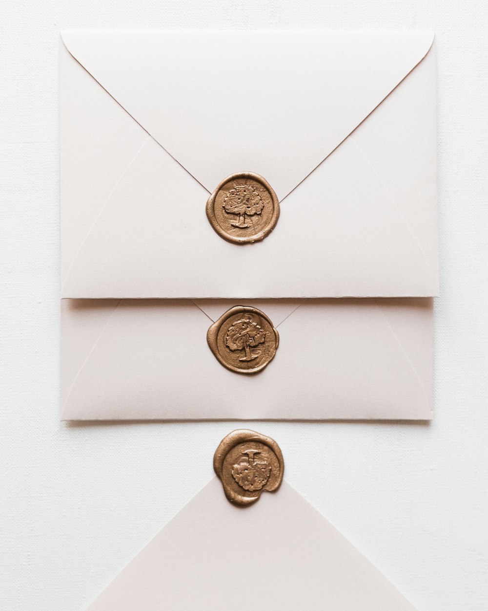 a white envelope with a wax stamp and a wax seal