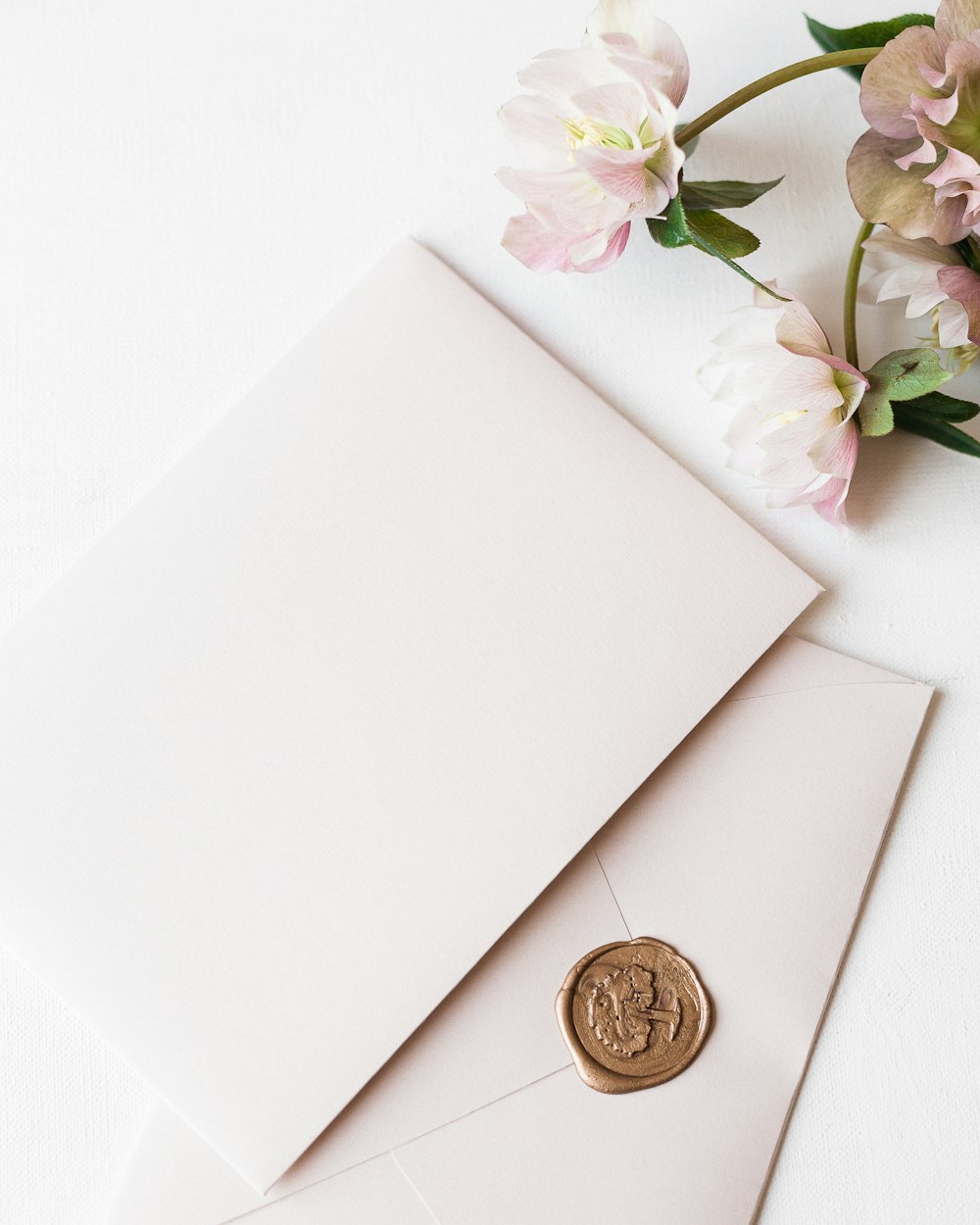 a white envelope with a wax stamp on it