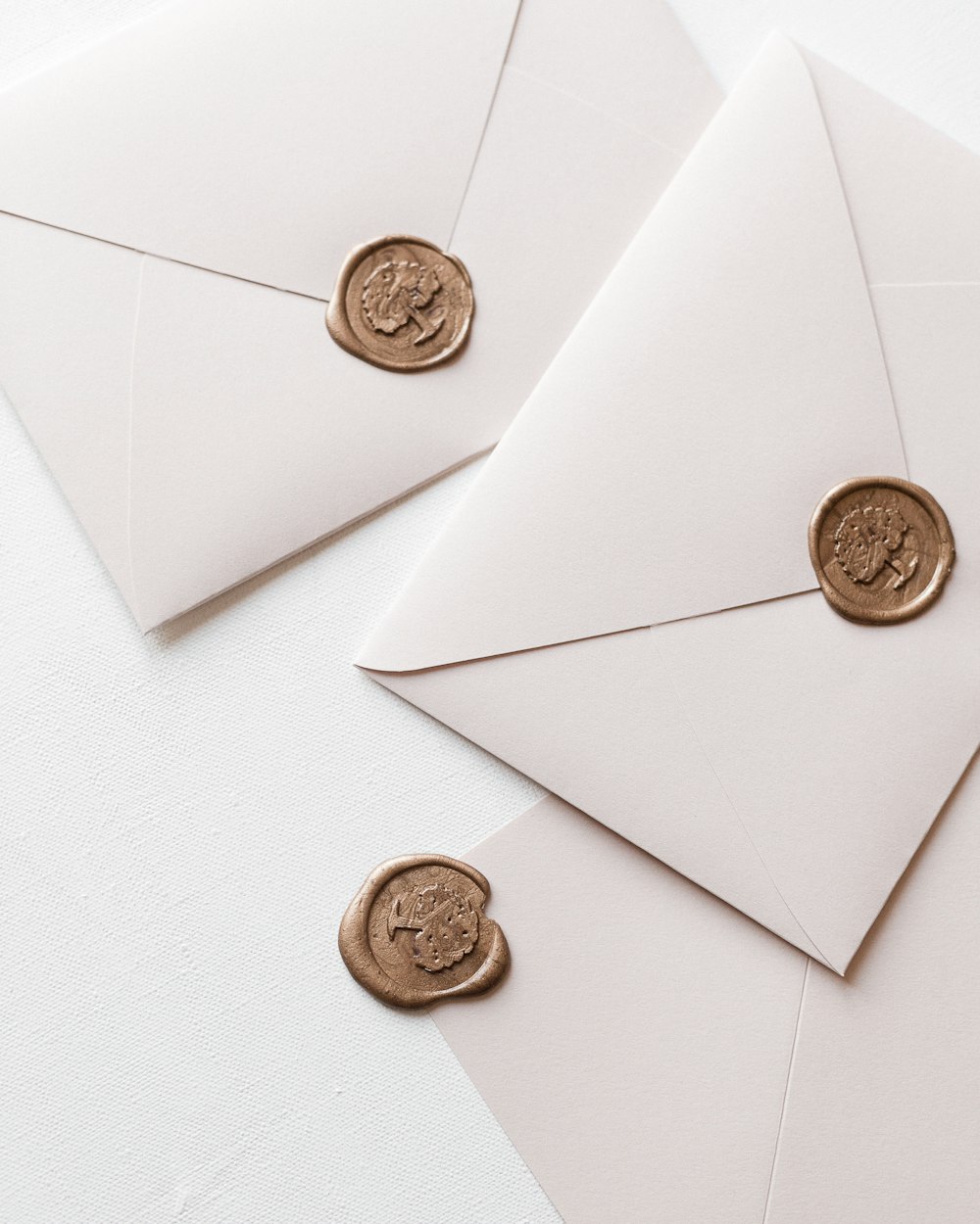 a close up of two envelopes with wax stamp on them