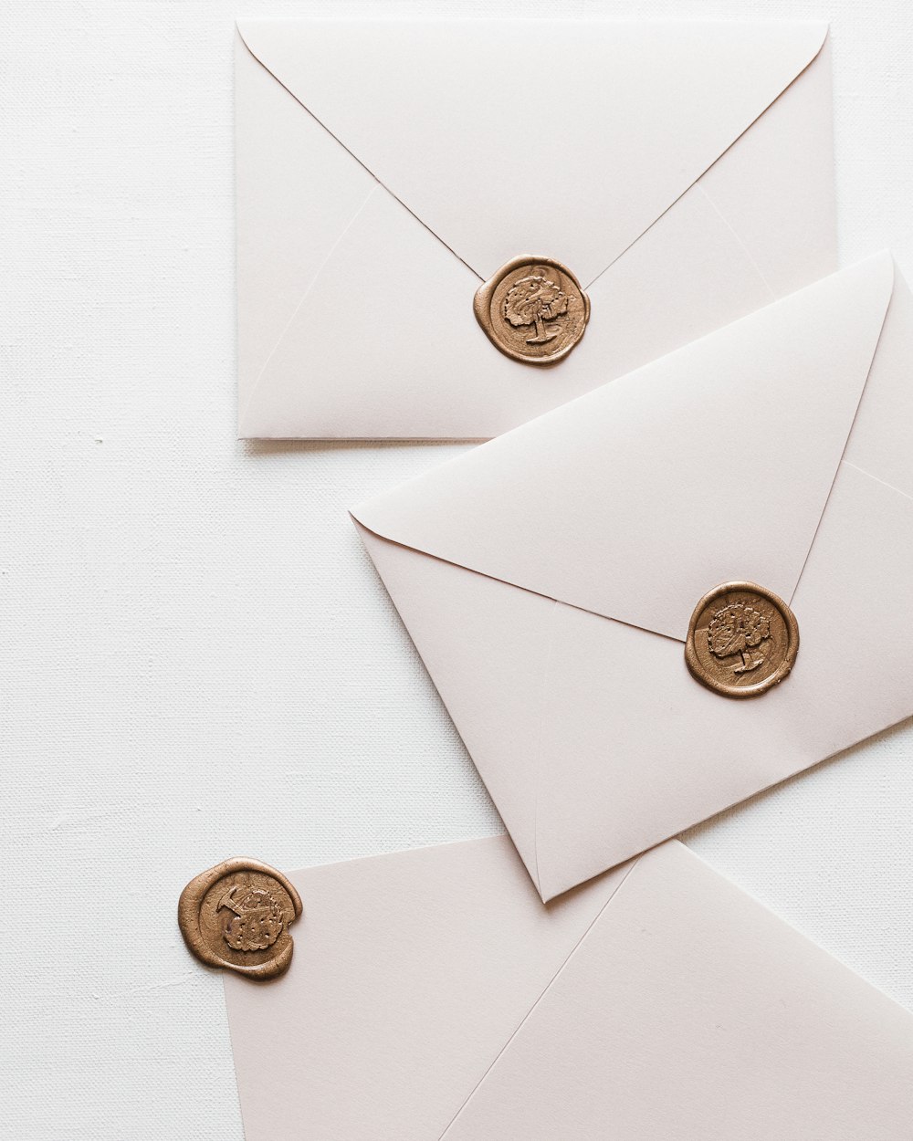 three envelopes with wax stamp on them