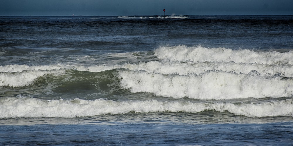 a person riding a surfboard on a wave in the ocean