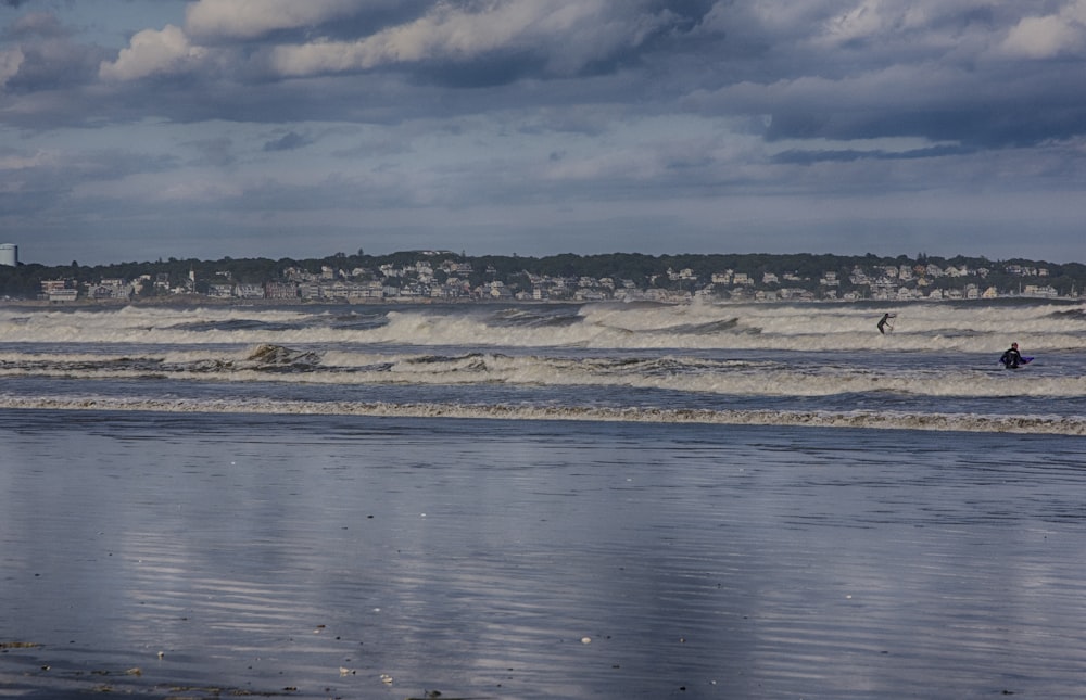 a man riding a surfboard on top of a wave in the ocean