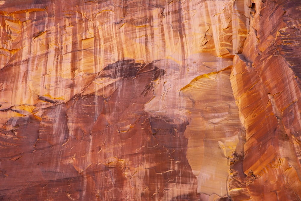 a large rock formation with yellow and brown colors