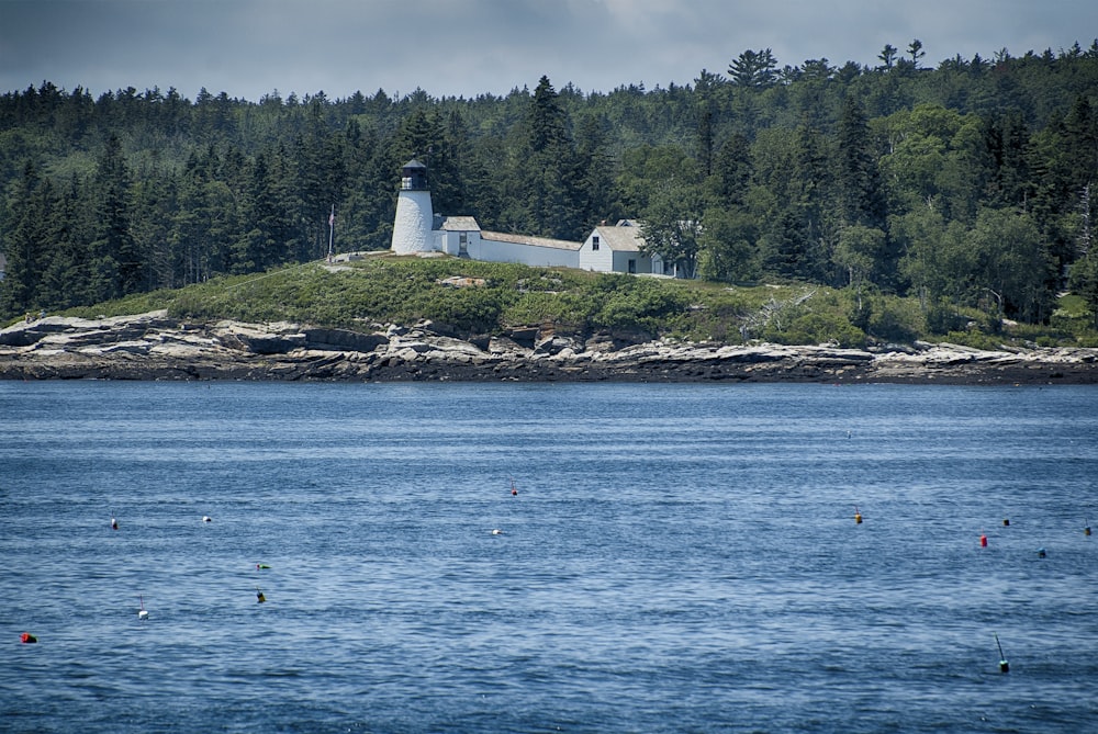 a lighthouse on a small island in the middle of the ocean