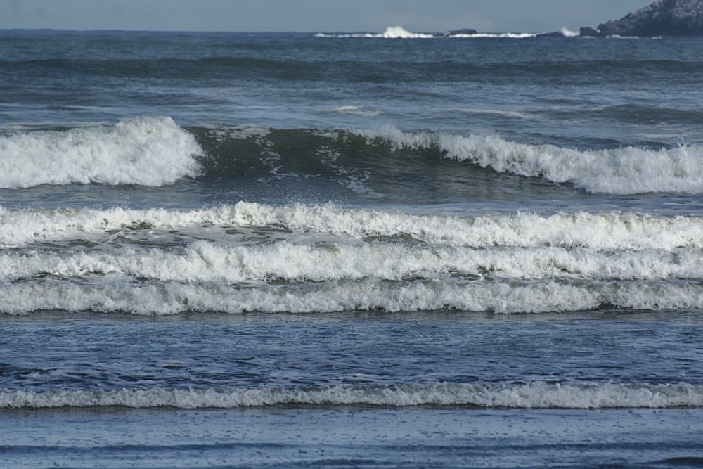 a man riding a wave on top of a surfboard