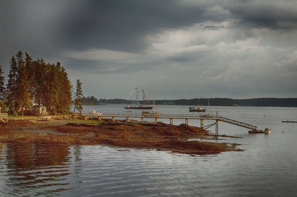 a dock on a lake with a boat in the distance