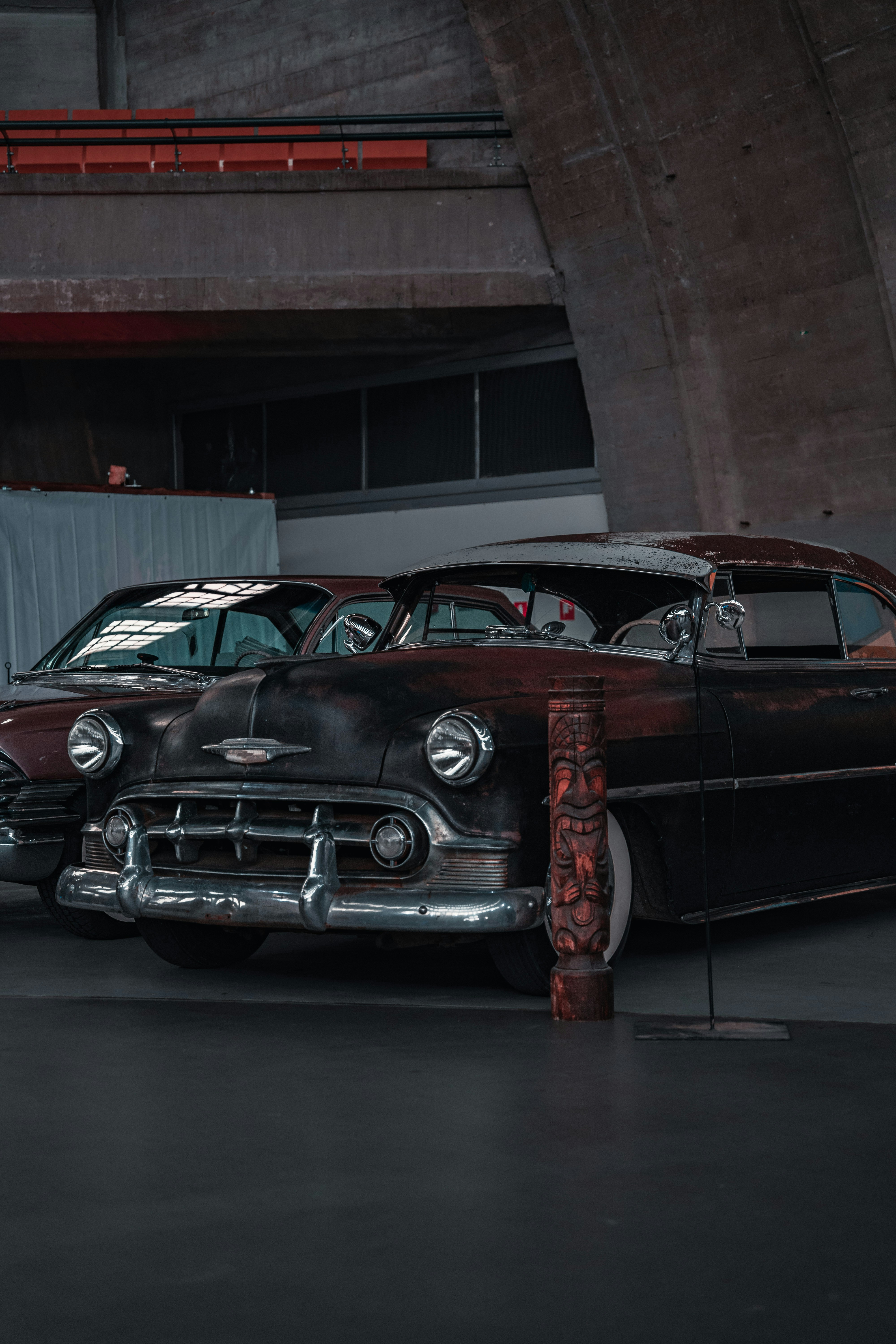 a couple of old cars parked next to each other