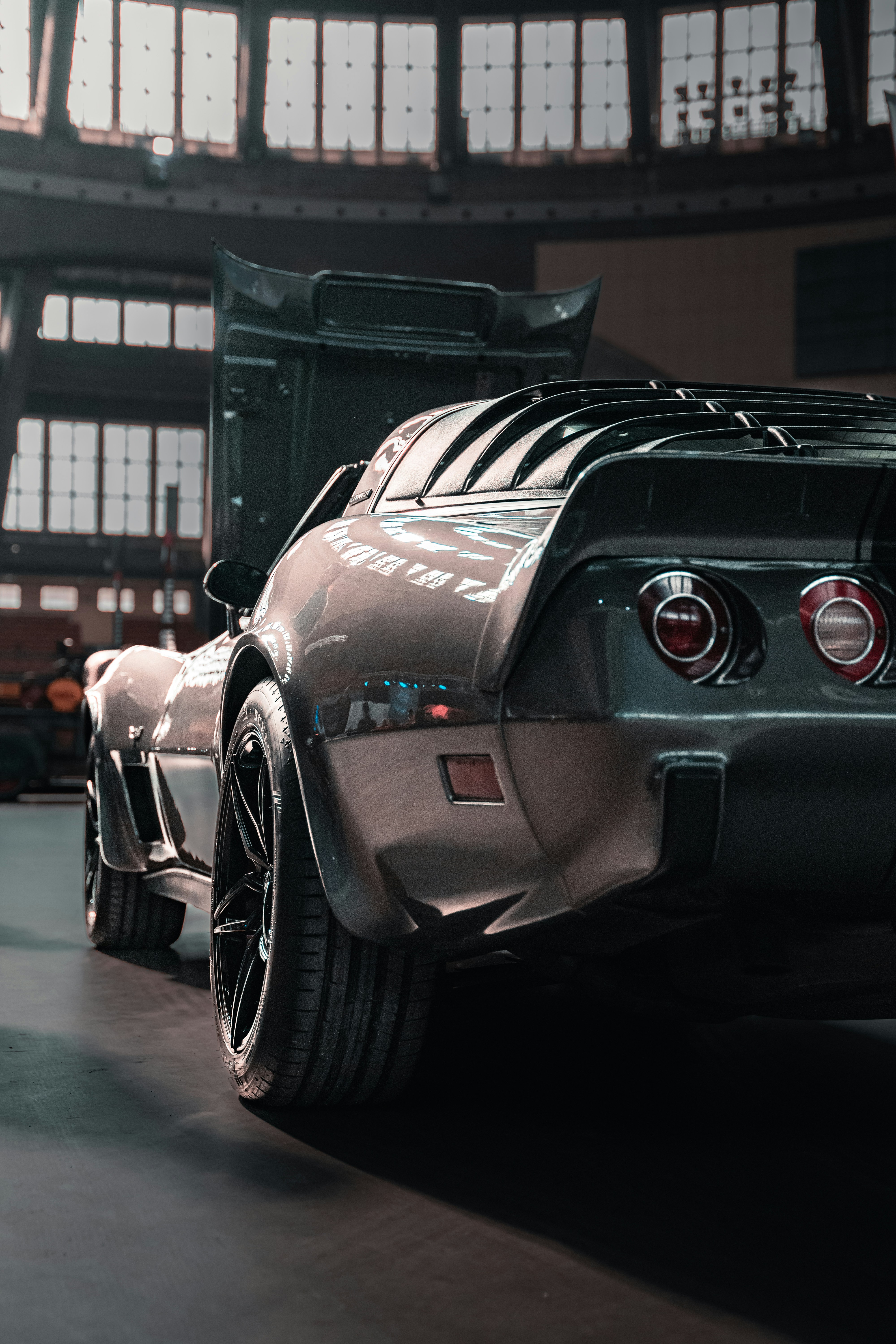 the rear end of a sports car parked in a garage