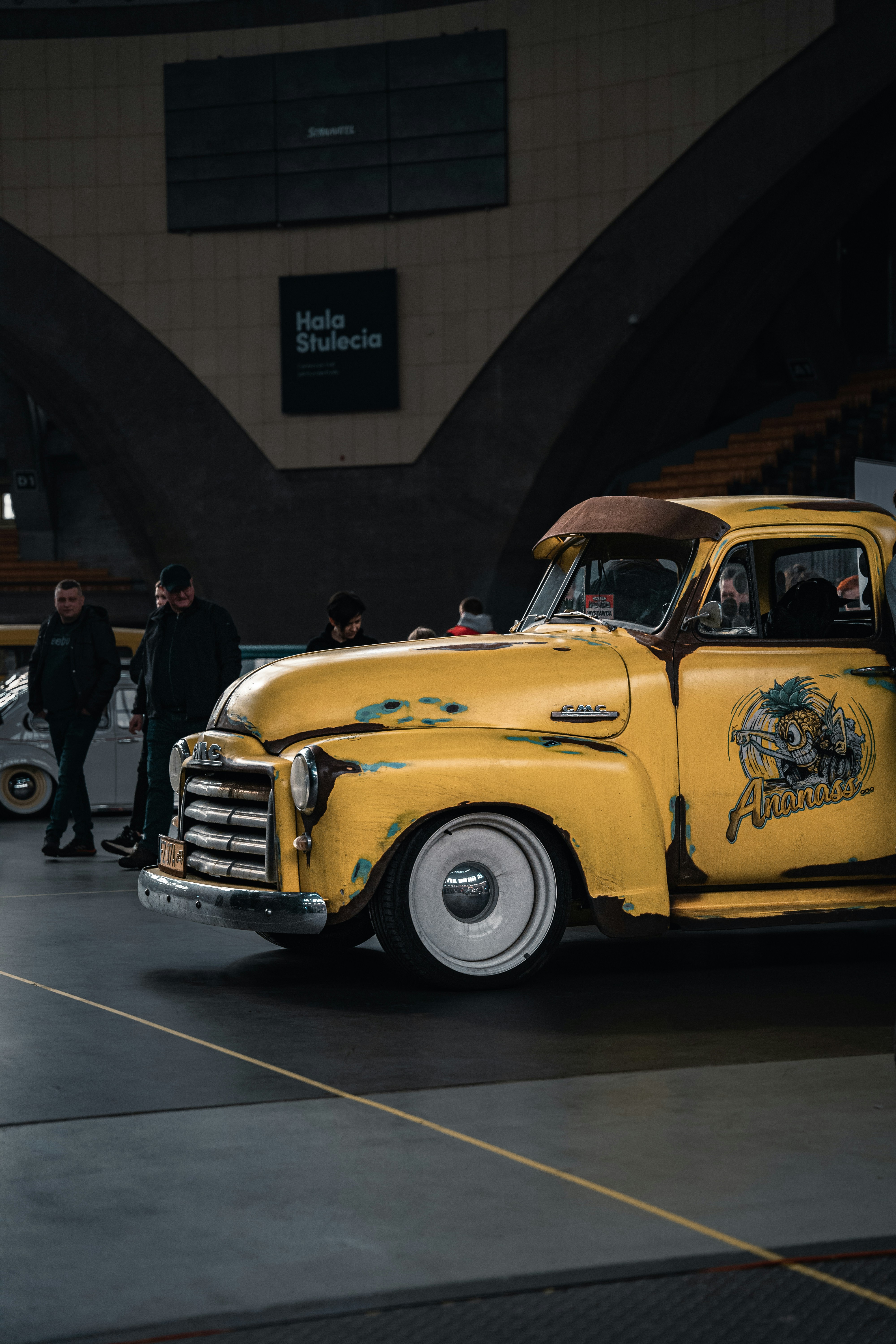 a yellow truck parked in front of a building