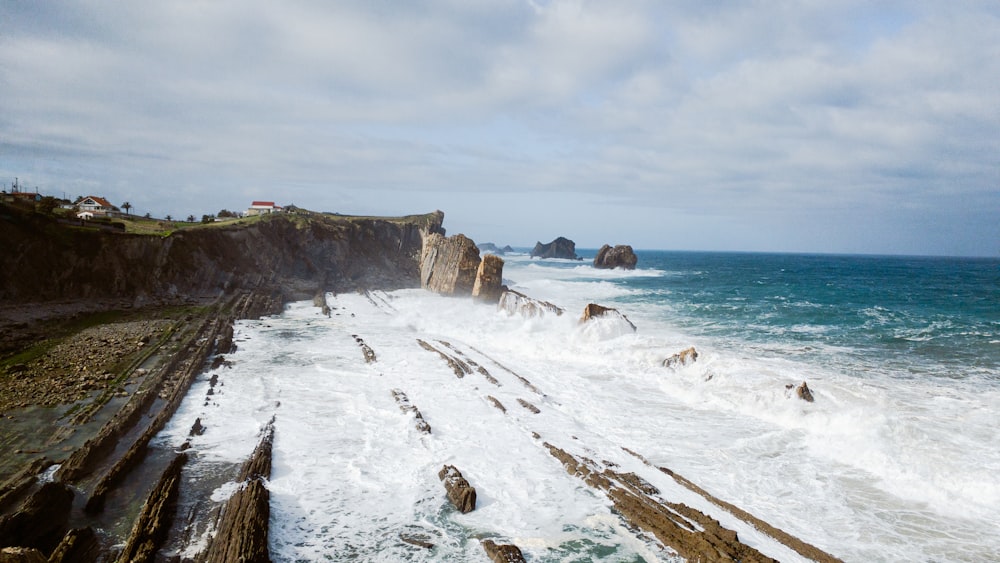 a rocky coastline with waves crashing against the rocks