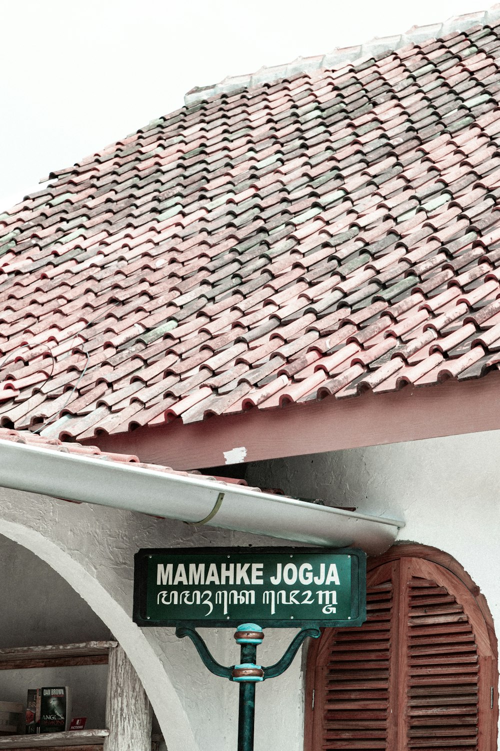 a green street sign in front of a building