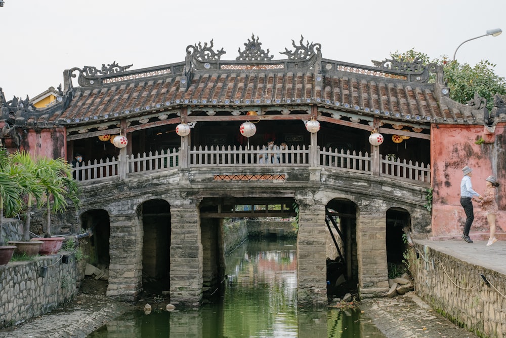 a bridge over a body of water near a building