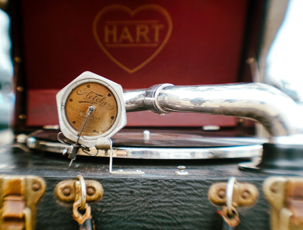 a close up of a clock on a piece of luggage