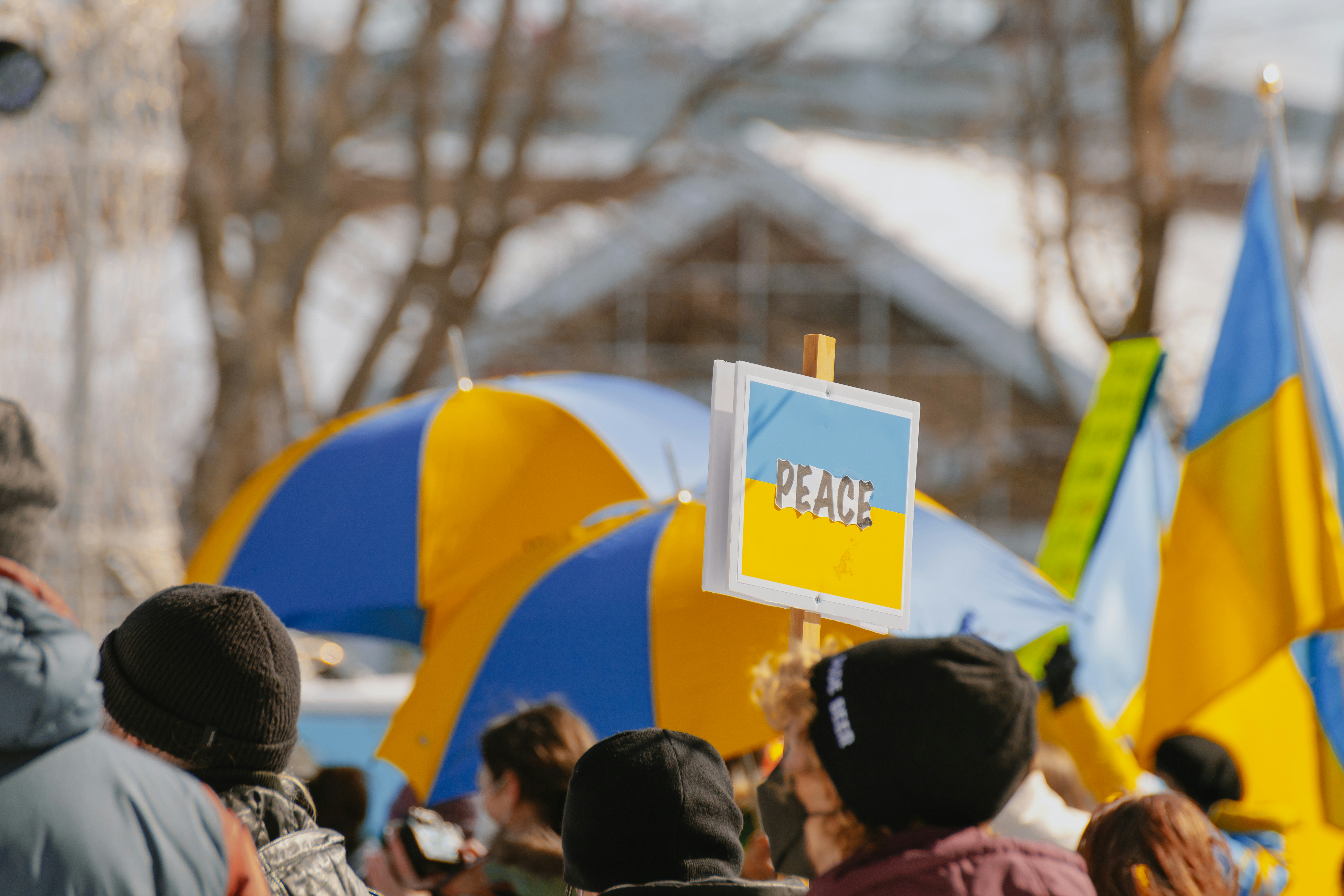 a group of people standing around holding signs