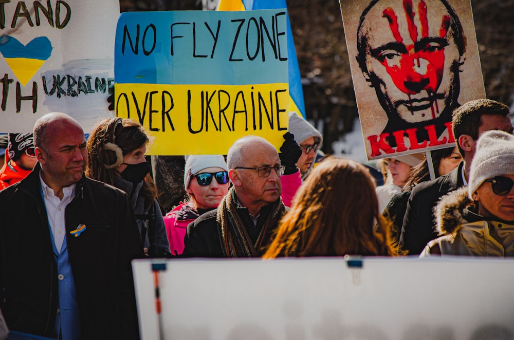 a group of people holding up signs in a protest