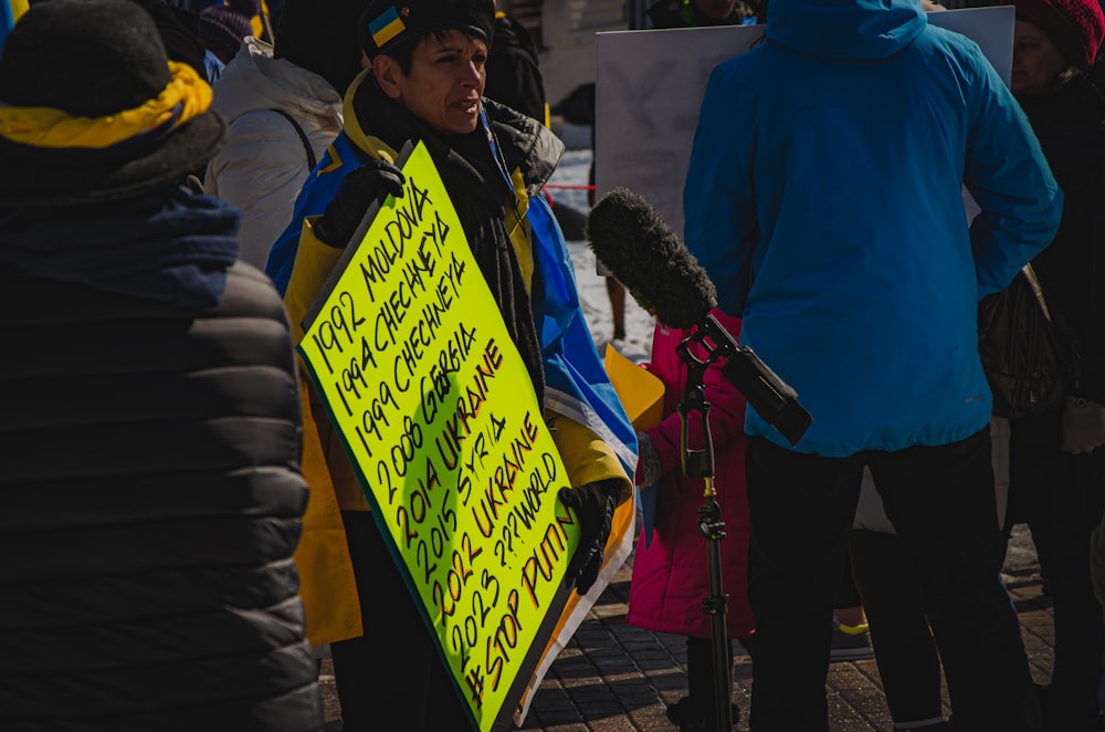 a person holding a sign and a microphone