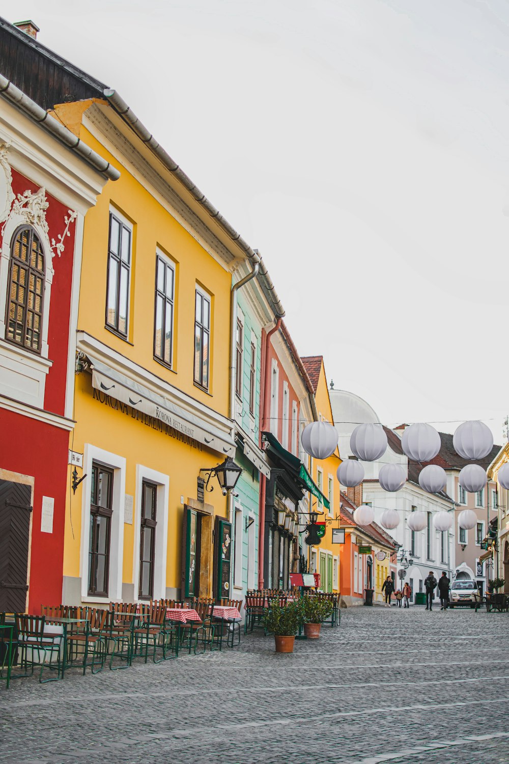 a cobblestone street lined with colorful buildings