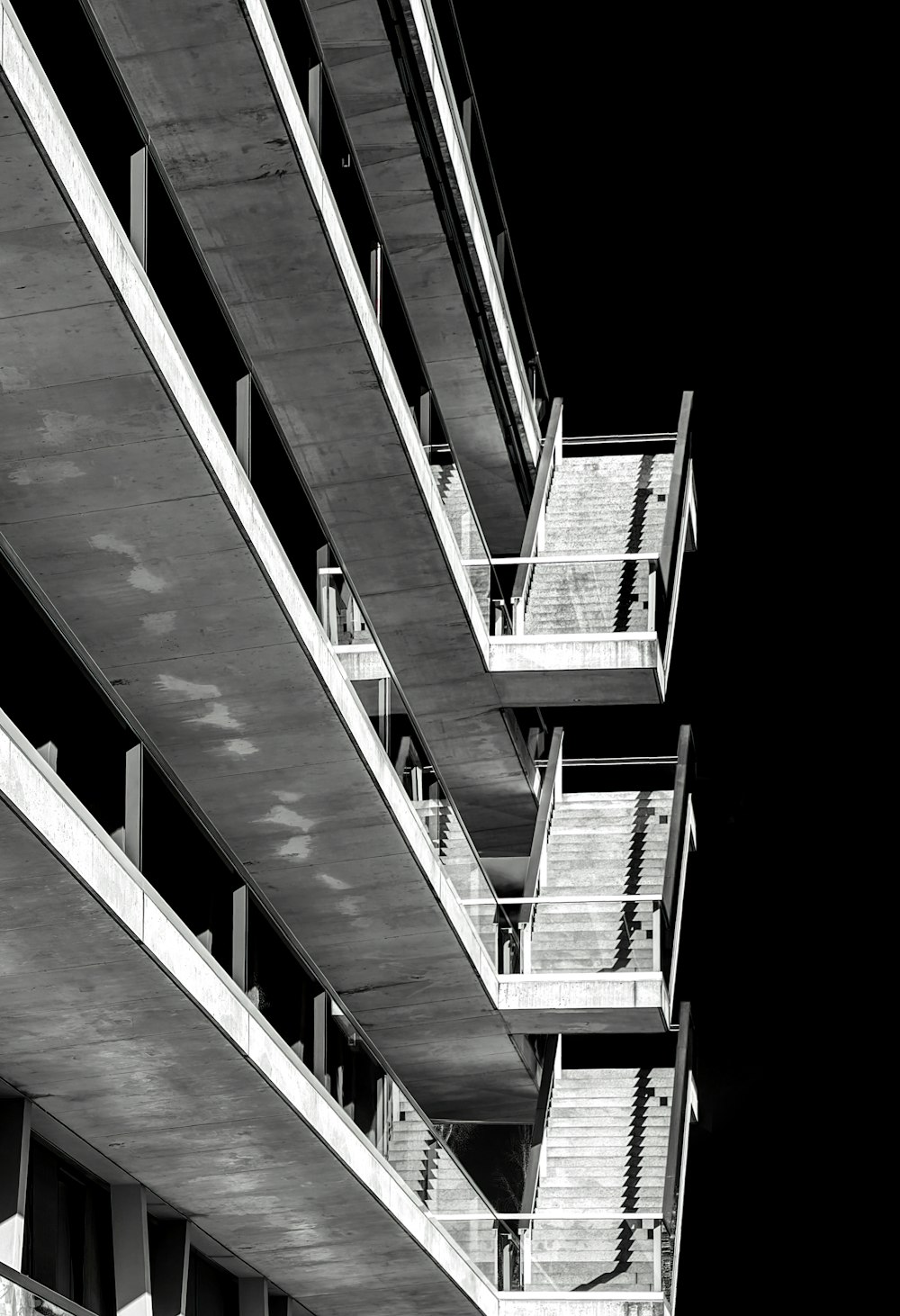 a black and white photo of a building with balconies