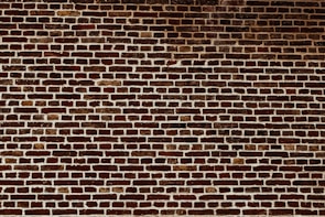 a brick wall with a stop sign on it