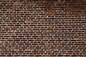 a brick wall with a stop sign on it