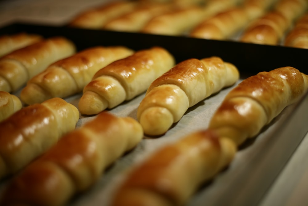 a bunch of croissants that are on a tray