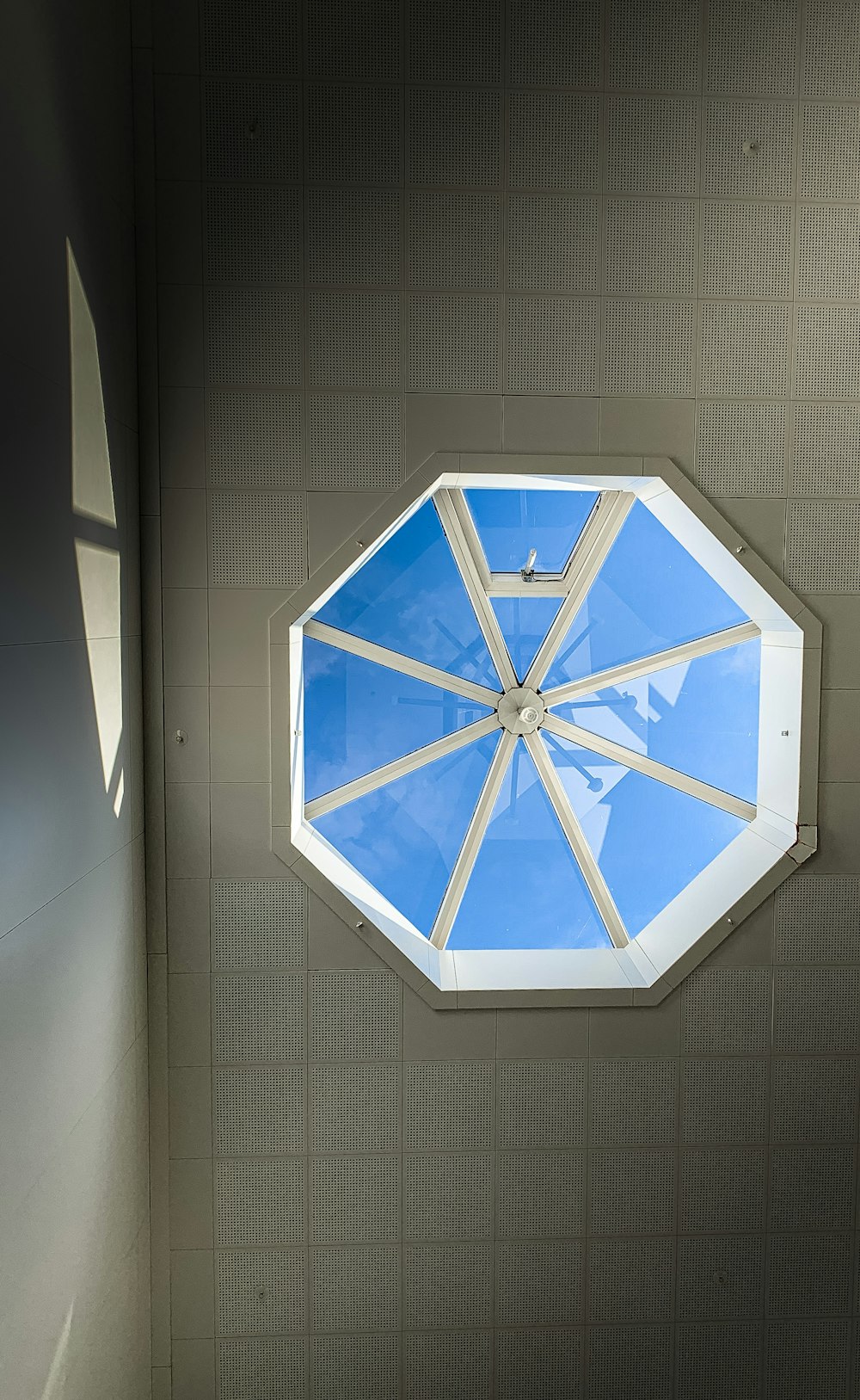 a blue umbrella hanging from the side of a wall