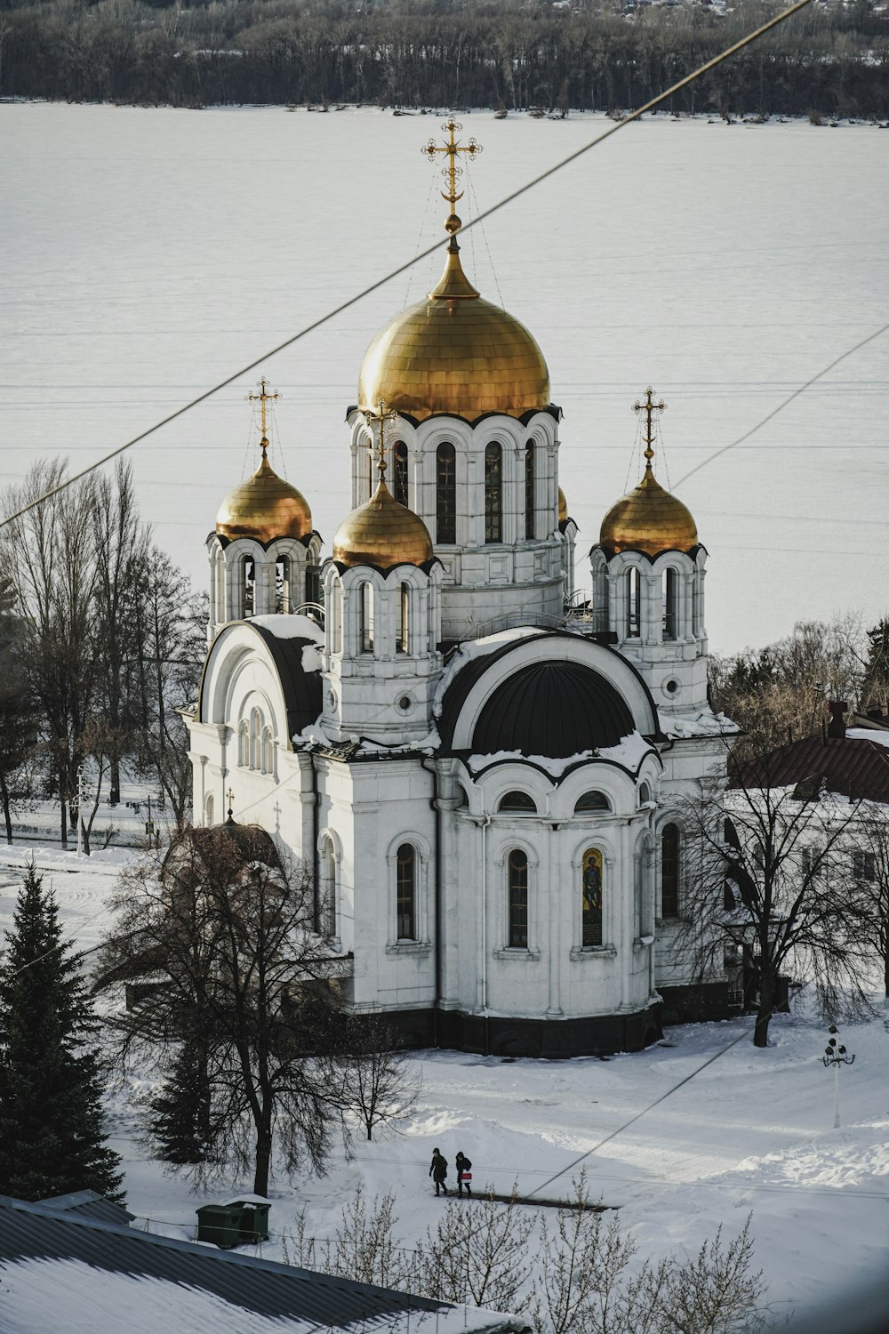 an aerial view of a church in the snow