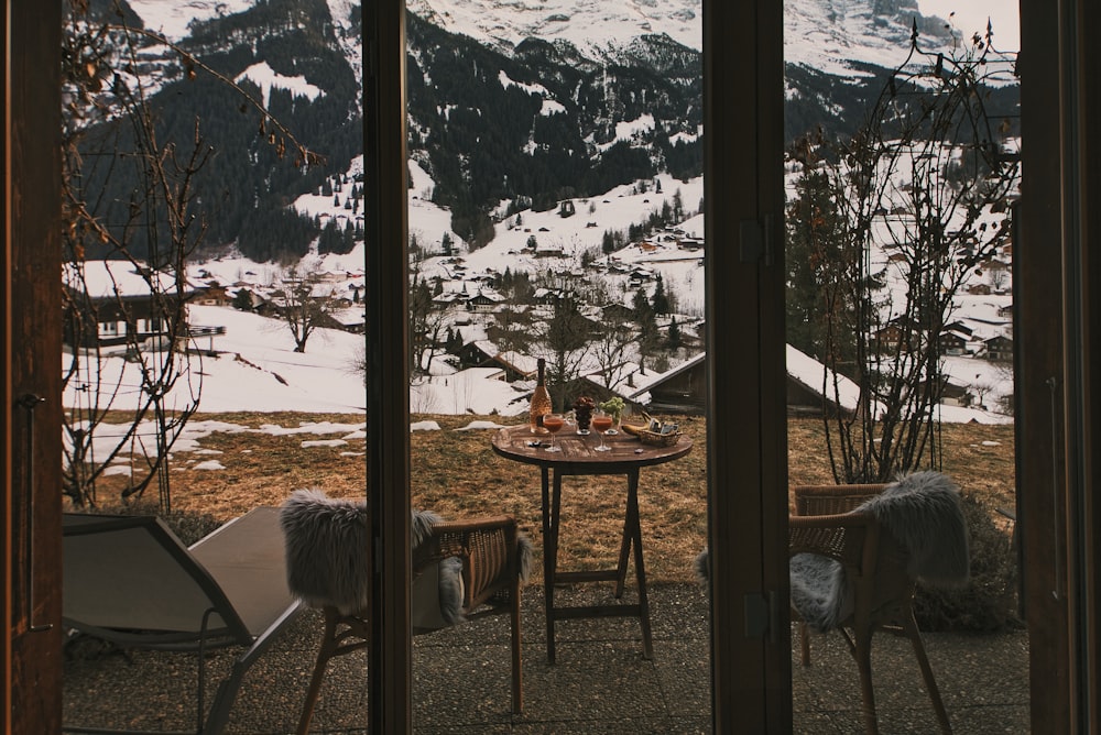 a view of a snow covered mountain from a patio