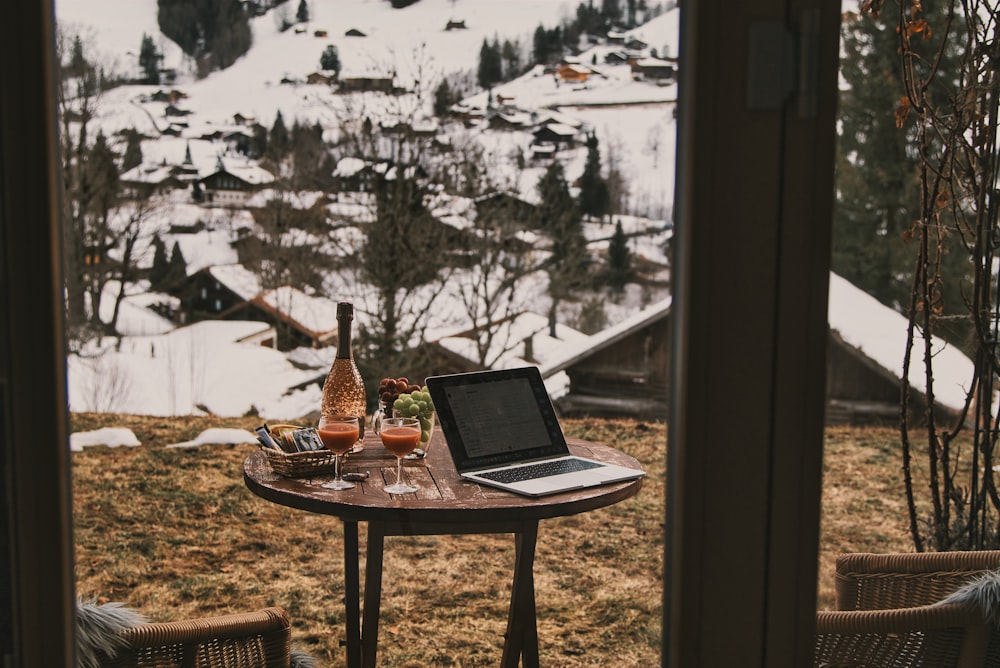 a laptop computer sitting on top of a wooden table