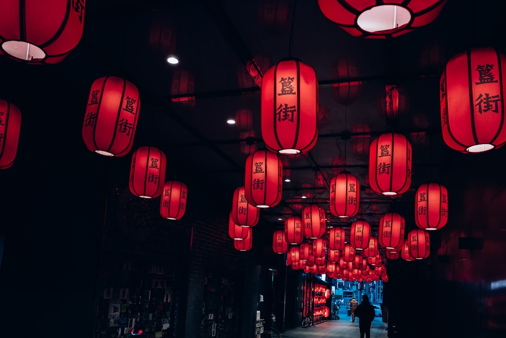 a hallway with red lanterns hanging from the ceiling